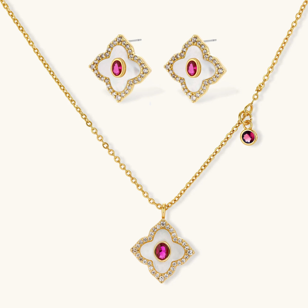 Gold-plated quatrefoil necklace and earring set with white enamel, pink cubic zirconia centers, and crystal borders