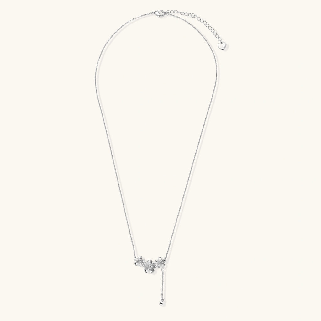 White gold plated Y-shaped necklace with three dimensional flower charms and adjustable drop pendant