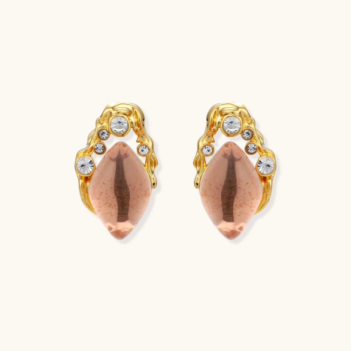 Gold-plated baroque stud earrings with coral-pink liuli stones and cubic zirconia crystals on white background.